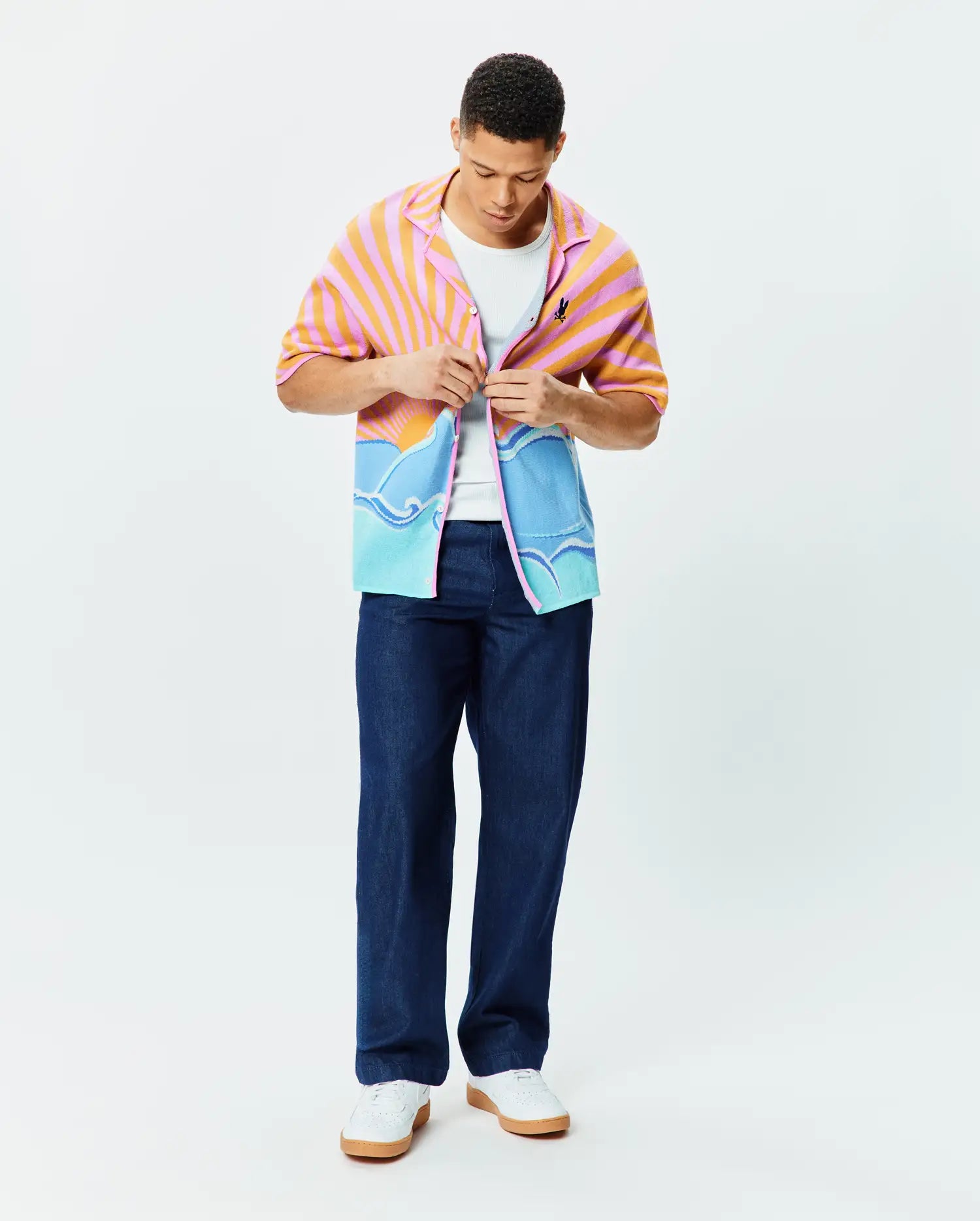 Mens Ray Relaxed Fit Jacquard Shirt featuring a vibrant pink and orange sunrise over blue ocean waves pattern, with a small embroidered Psycho Bunny skull logo on the chest.