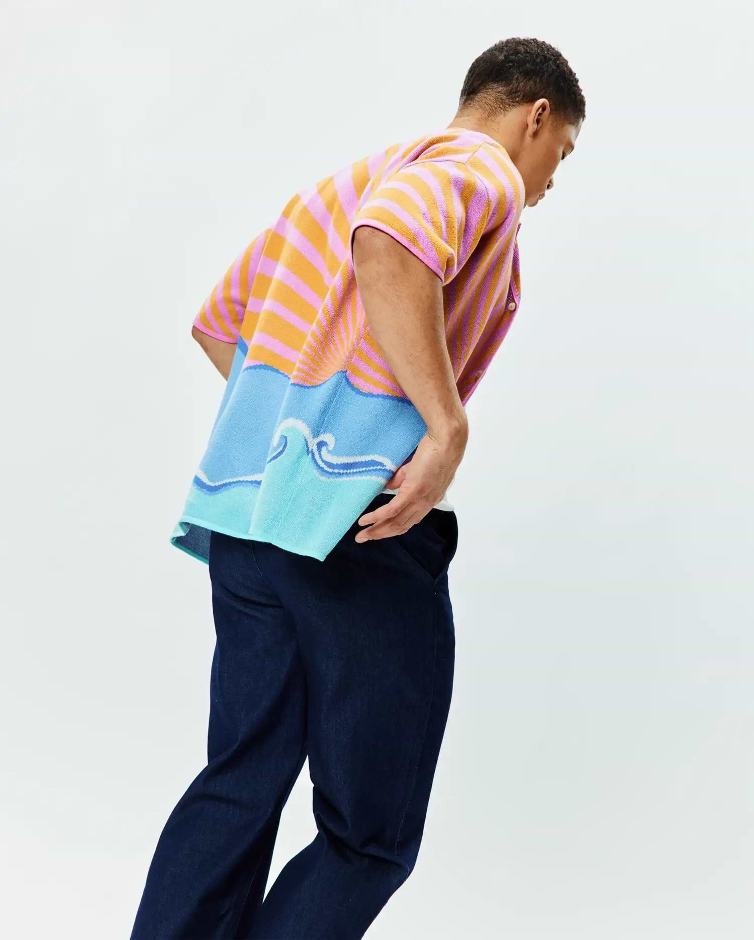 Mens Ray Relaxed Fit Jacquard Shirt featuring vibrant pink and orange horizontal stripes transitioning to a blue and light blue ocean wave graphic with a rising sun motif, crafted in a soft, textured knit.