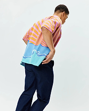 Mens Ray Relaxed Fit Jacquard Shirt featuring vibrant pink and orange horizontal stripes transitioning to a blue and light blue ocean wave graphic with a rising sun motif, crafted in a soft, textured knit.