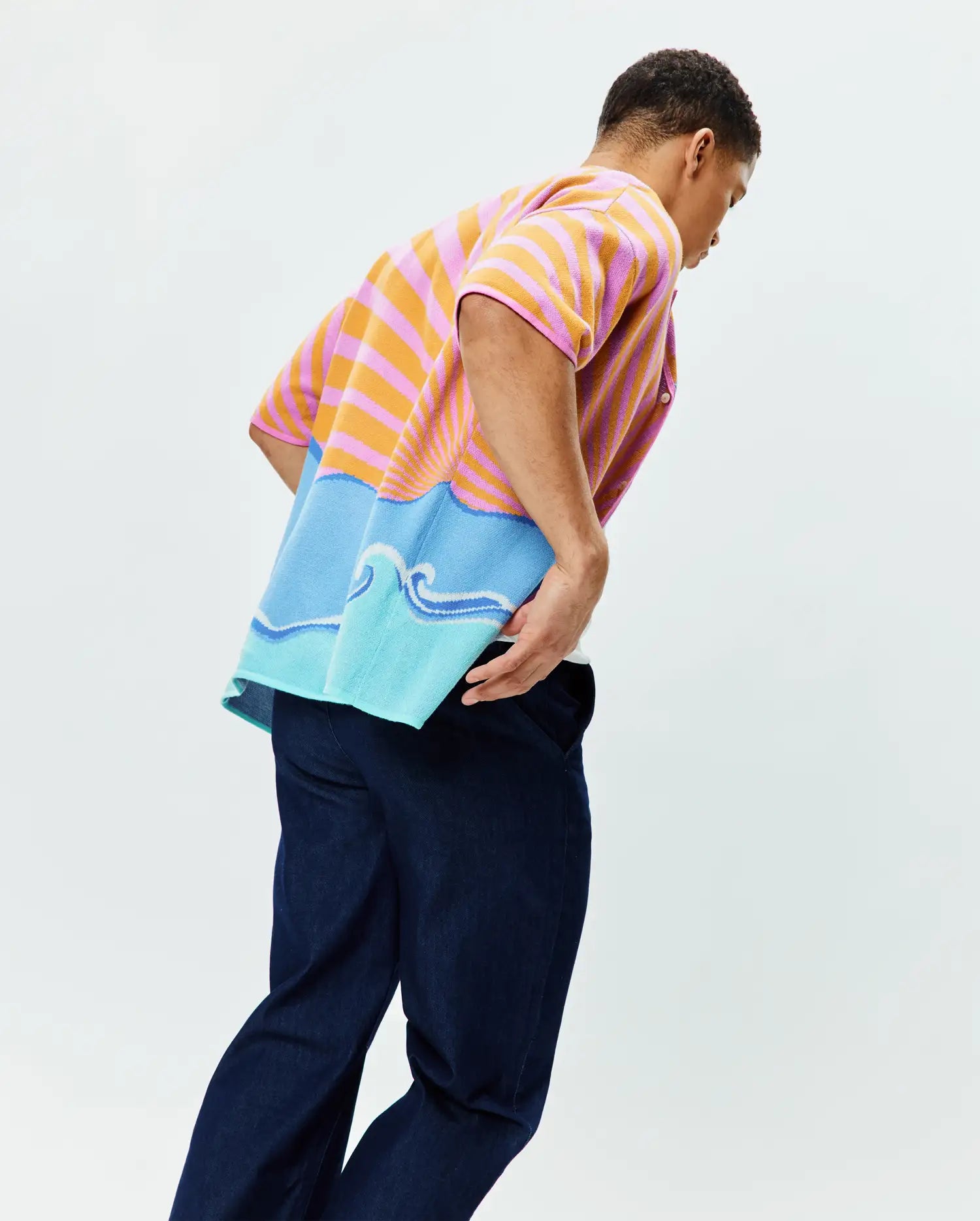 Mens Ray Relaxed Fit Jacquard Shirt featuring vibrant pink and orange horizontal stripes transitioning to a blue and light blue ocean wave graphic with a rising sun motif, crafted in a soft, textured knit.