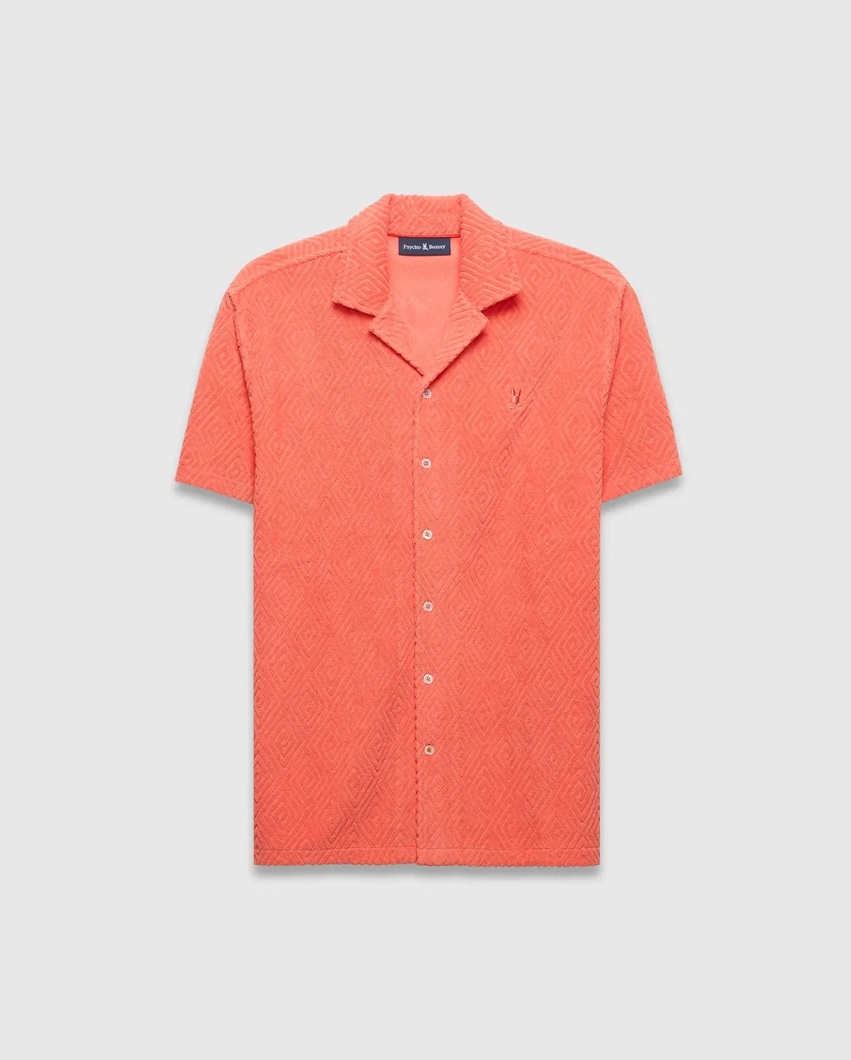 Mens Tristan Shirt, coral relaxed fit short-sleeve camp collar shirt with textured diamond jacquard pattern and small embroidered Psycho Bunny skull logo on left chest.