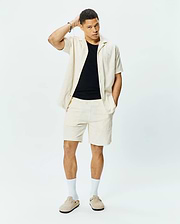 Mens Tristan Shirt. Relaxed fit cream short-sleeve shirt with an open collar and textured waffle knit geometric pattern, paired with matching cream shorts.