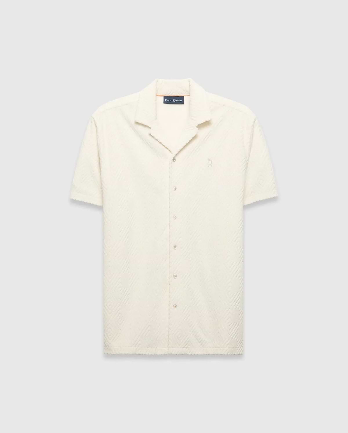 Mens Tristan Shirt, an ecru short-sleeve camp collar shirt in textured terry fabric with an all-over diamond pattern and a small embroidered Psycho Bunny logo on the left chest.