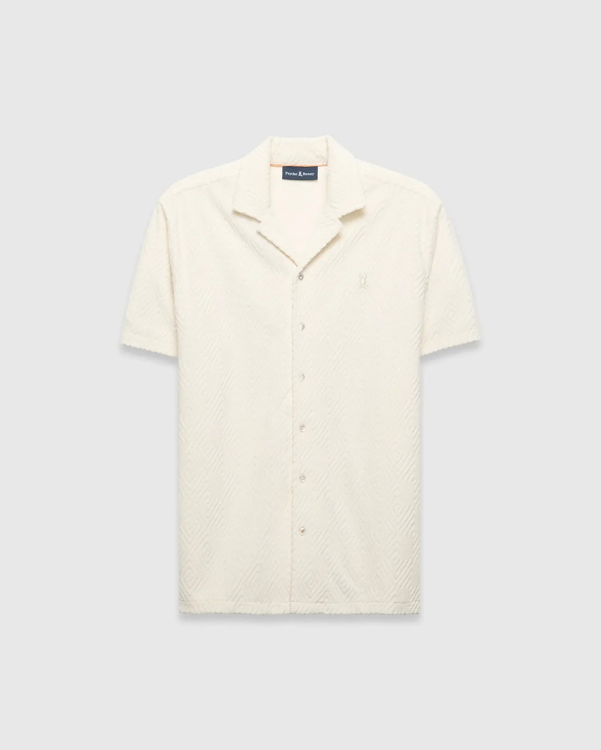 Mens Tristan Shirt, an ecru short-sleeve camp collar shirt in textured terry fabric with an all-over diamond pattern and a small embroidered Psycho Bunny logo on the left chest.