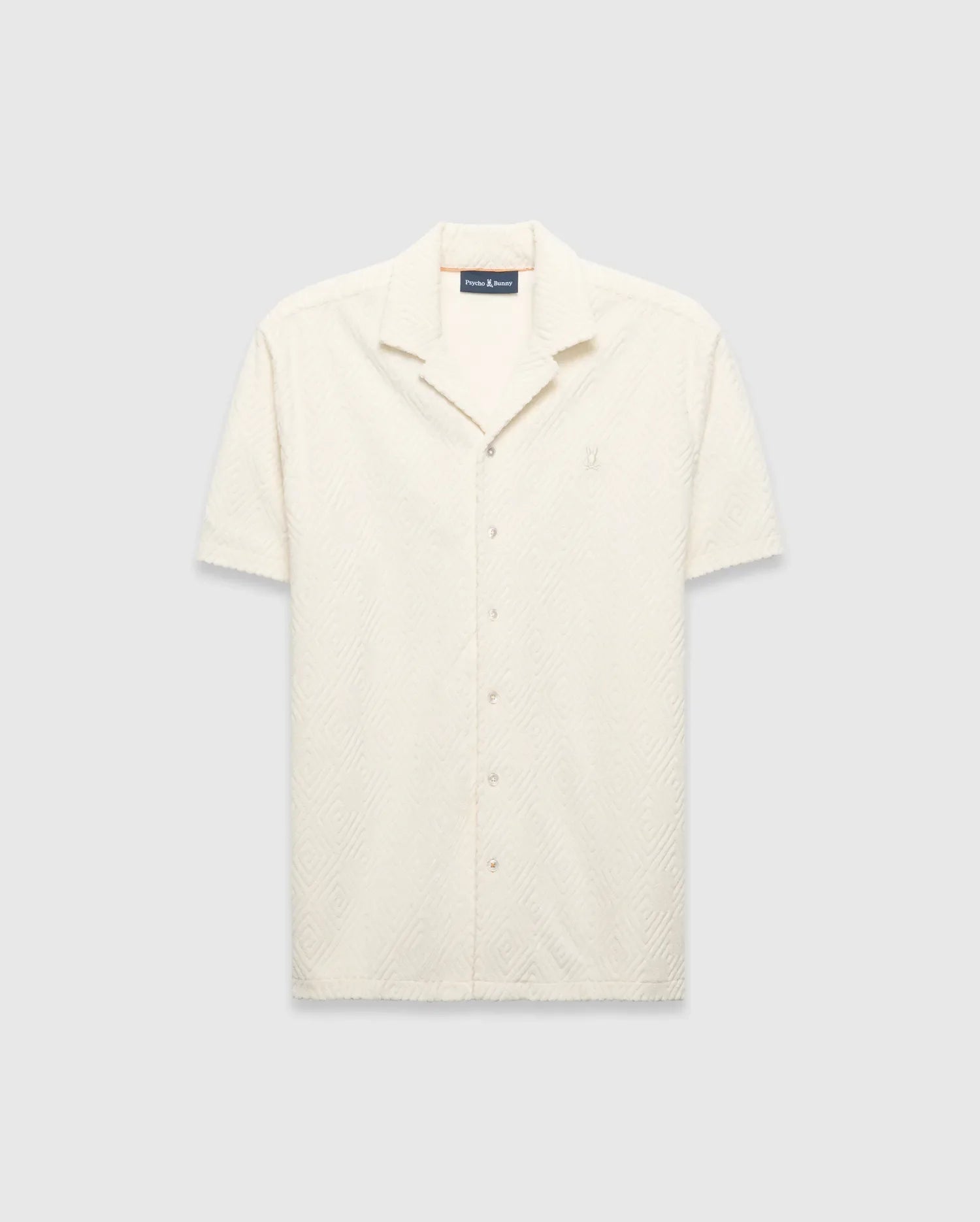 Mens Tristan Shirt, an ecru short-sleeve camp collar shirt in textured terry fabric with an all-over diamond pattern and a small embroidered Psycho Bunny logo on the left chest.