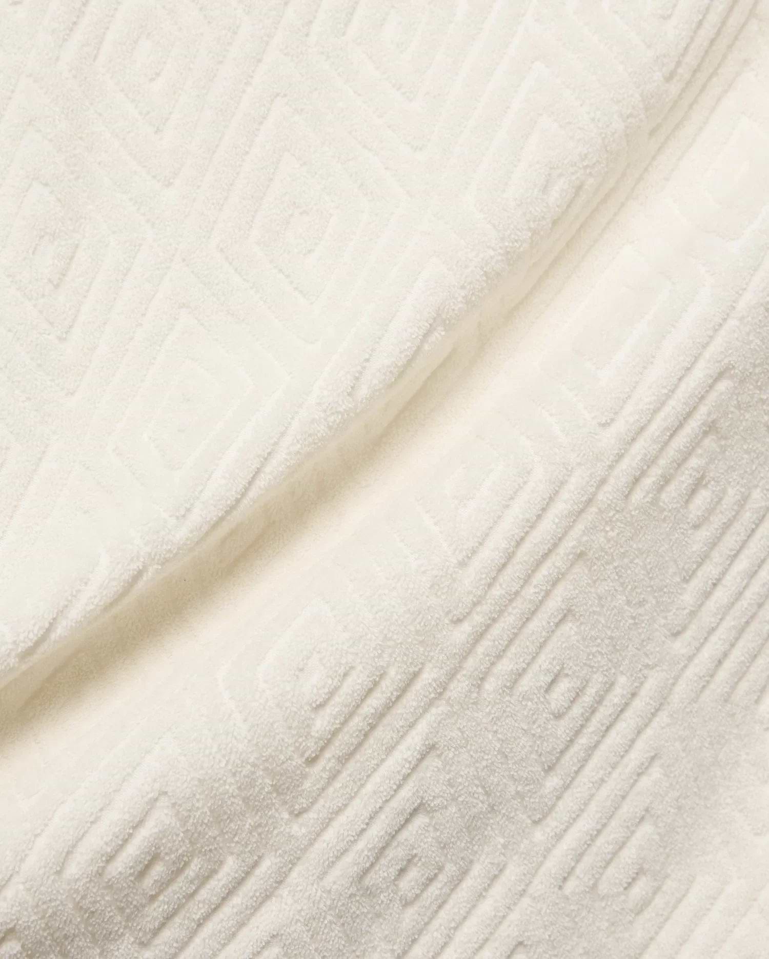 Mens Tristan Shirt in cream, a plush, textured jacquard fabric with an embossed interlocking geometric square pattern, reflecting Psycho Bunny's refined streetwear.