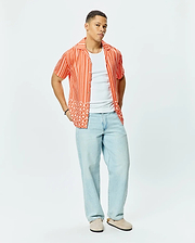 Mens Brad Tencel Shirt, a relaxed fit orange and white striped short-sleeve button-up with a unique white palm tree and small Psycho Bunny skull logo pattern on the lower hem.
