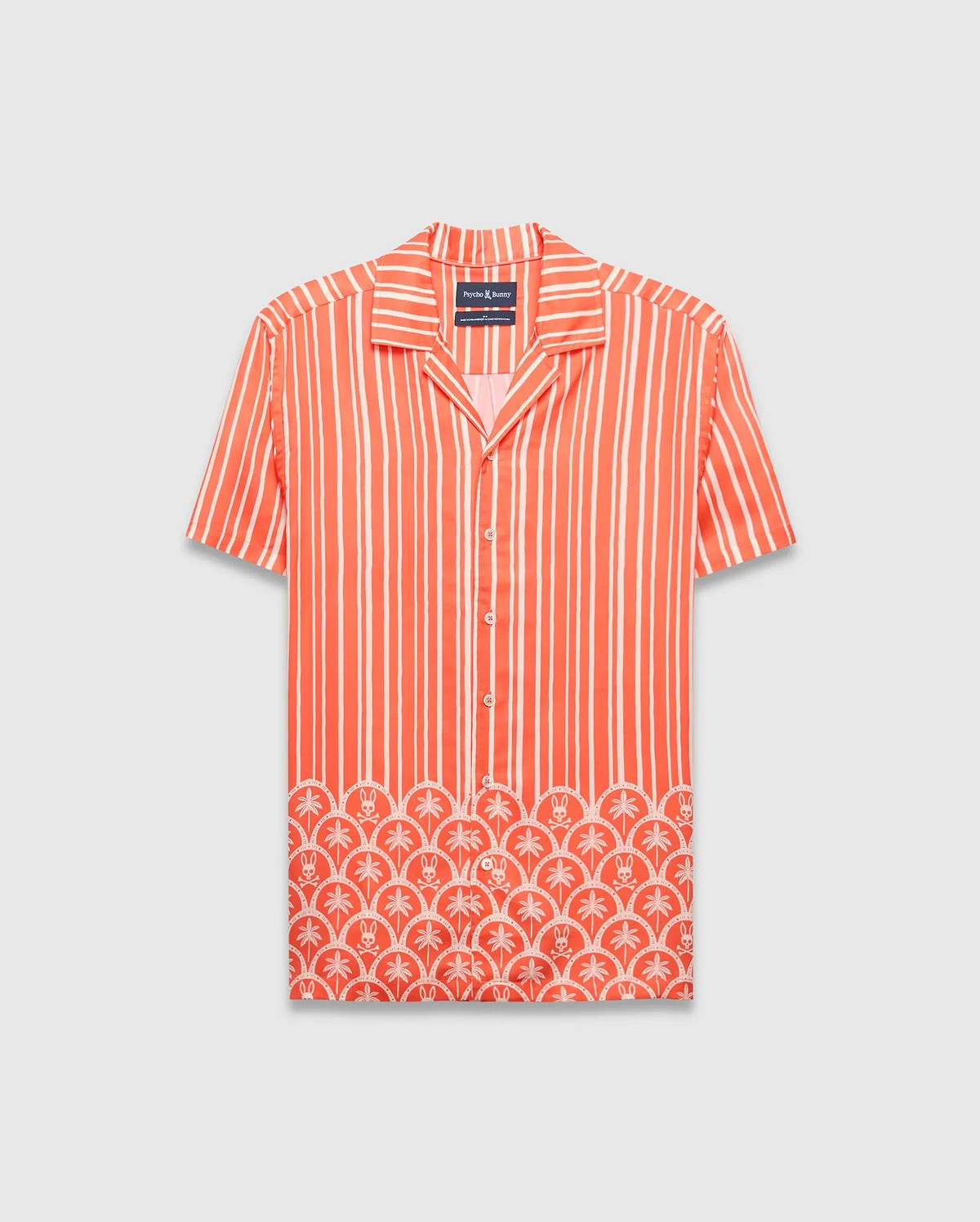 Coral orange Mens Brad Tencel Shirt, a relaxed fit camp collar shirt with white vertical stripes. The lower hem features a white scalloped pattern incorporating palm trees and small Psycho Bunny skull logos.