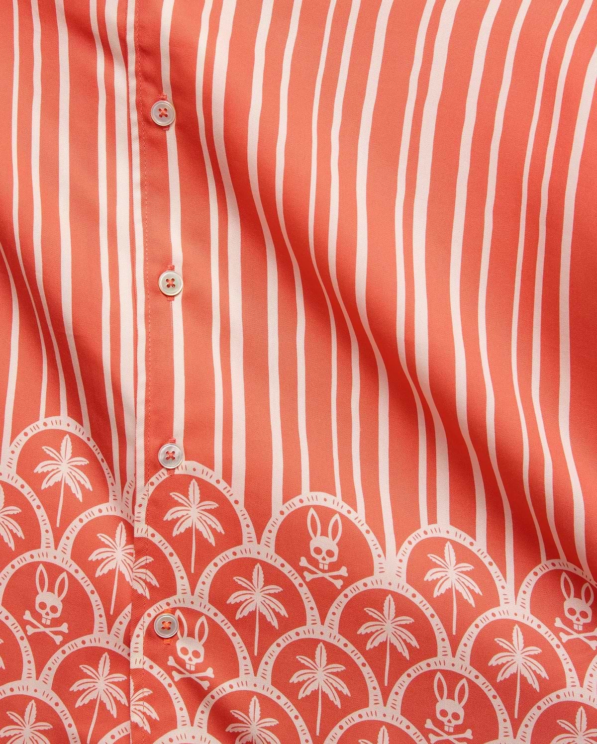 Mens Brad Tencel Shirt in coral with white vertical stripes and a bottom border featuring white palm trees and Psycho Bunny skull logos in a scalloped pattern, with white buttons.