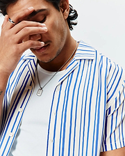 Mens Brad Tencel Shirt, a relaxed fit white camp collar shirt featuring prominent vertical blue stripes, a smooth, soft Tencel fabric, and light-colored button-front closure.