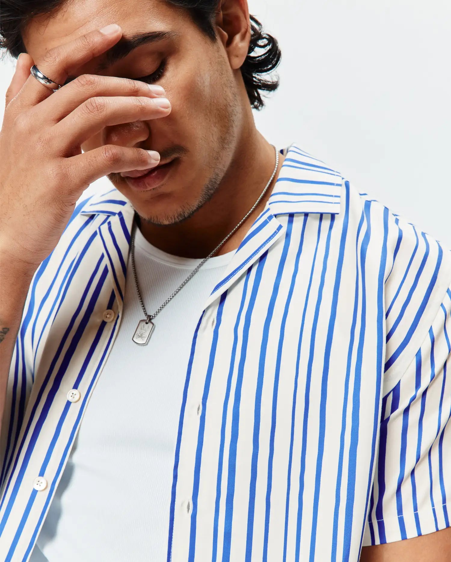 Mens Brad Tencel Shirt, a relaxed fit white camp collar shirt featuring prominent vertical blue stripes, a smooth, soft Tencel fabric, and light-colored button-front closure.