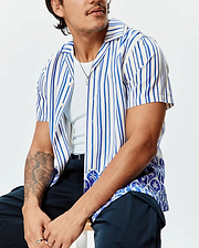 Mens Brad Tencel Shirt: Relaxed fit cream and royal blue striped short-sleeve camp collar shirt with an intricate blue and white patterned hem featuring subtle bunny skull motifs.
