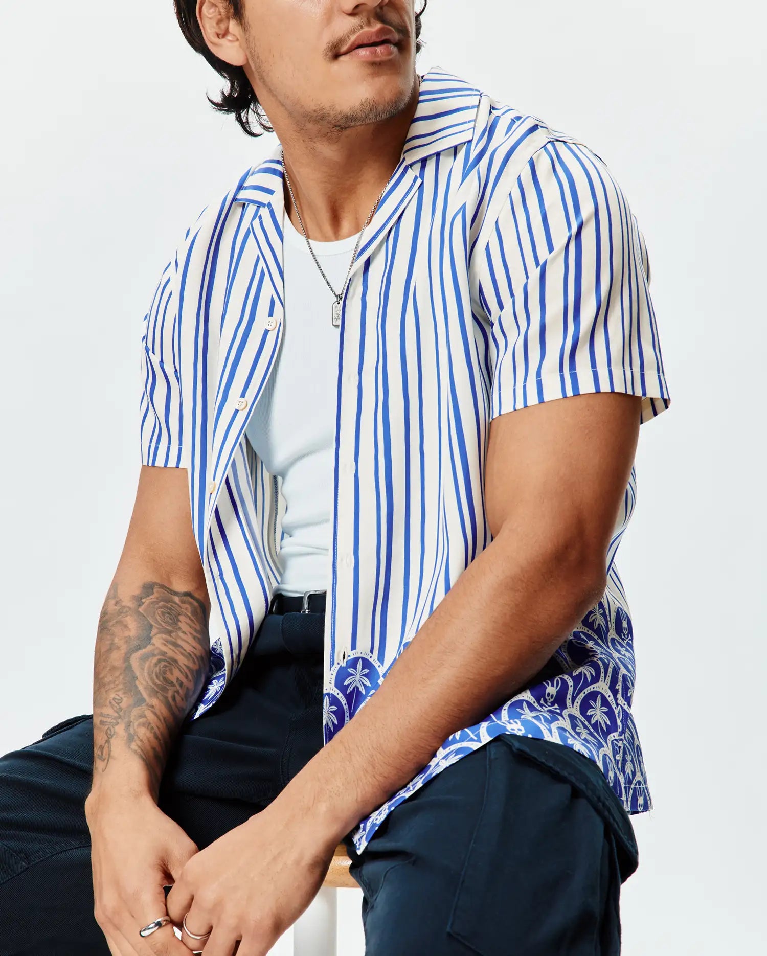 Mens Brad Tencel Shirt: Relaxed fit cream and royal blue striped short-sleeve camp collar shirt with an intricate blue and white patterned hem featuring subtle bunny skull motifs.