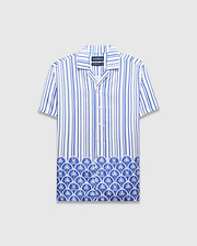 Mens Brad Tencel Shirt, a relaxed fit white and blue striped short-sleeve button-up with a unique Psycho Bunny skull and palm tree pattern along the hem.