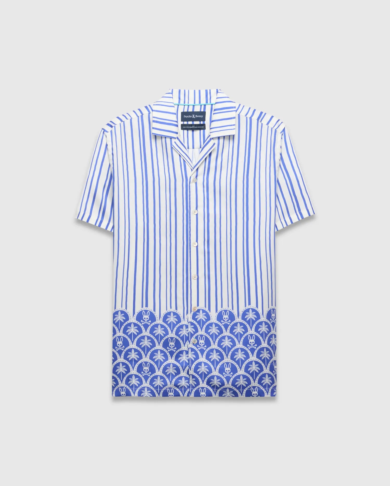 Mens Brad Tencel Shirt, a relaxed fit white and blue striped short-sleeve button-up with a unique Psycho Bunny skull and palm tree pattern along the hem.