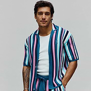 Mens Cliff Shirt, a relaxed fit, short-sleeve knit shirt featuring bold vertical stripes in teal, pink, white, and navy. Small embroidered Psycho Bunny skull logo on the left chest.