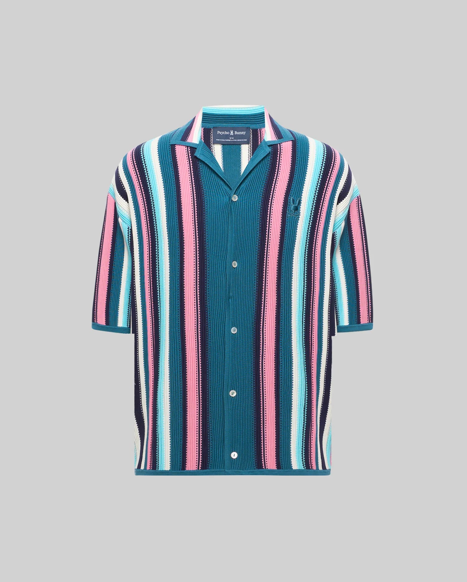Mens Cliff Shirt, a relaxed fit knit shirt with bold vertical stripes in teal, pink, light blue, white, and navy, featuring a spread collar and an embroidered Psycho Bunny skull logo on the left chest.