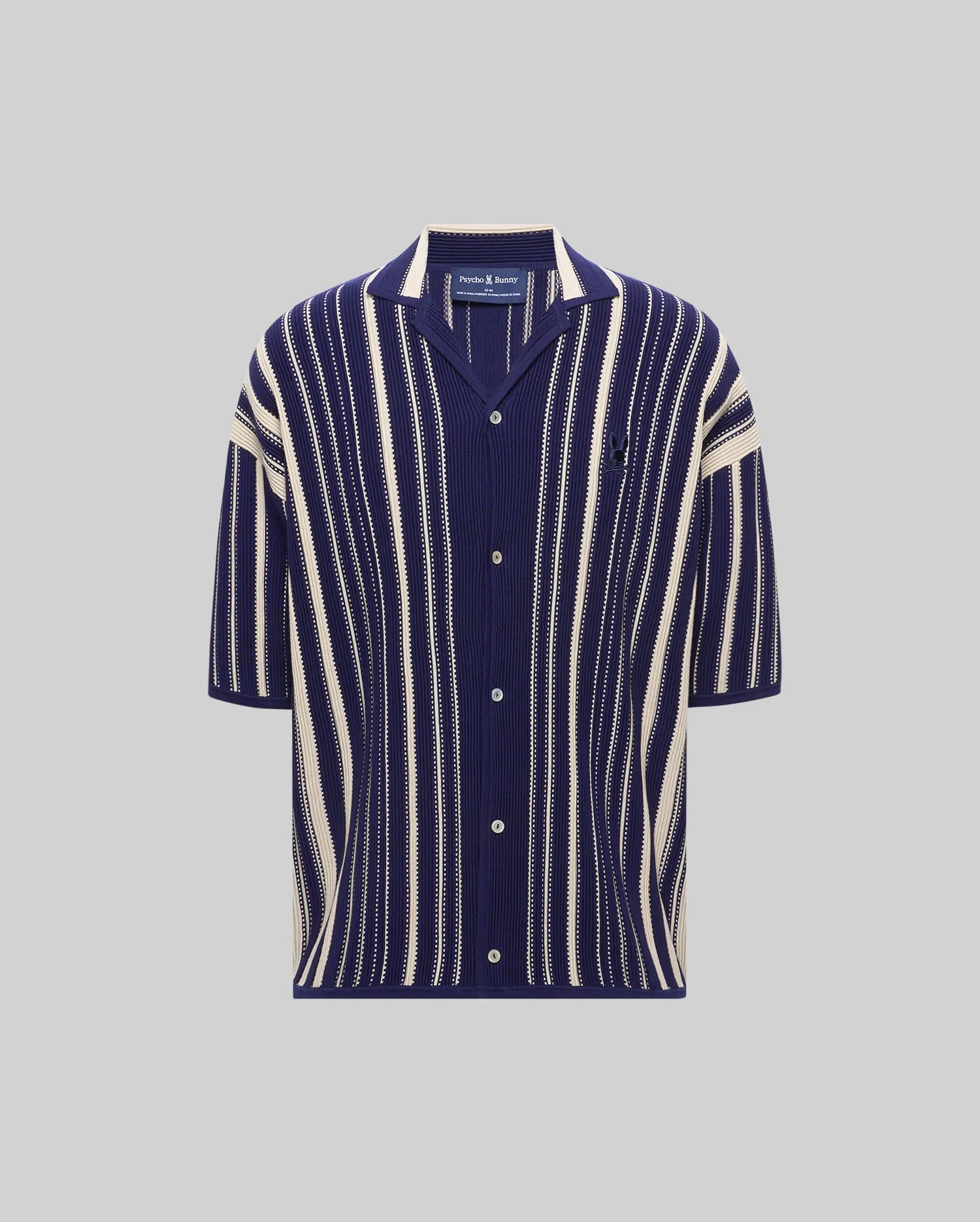 MENS CLIFF SHIRT, a relaxed fit navy blue and cream vertical striped ribbed knit short-sleeve shirt with a spread collar, full button placket, and small embroidered Psycho Bunny skull logo on the left chest.