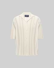 Mens Cliff Shirt, a relaxed fit cream ribbed knit short-sleeve button-up with subtle beige vertical stripes, camp collar, and small embroidered Psycho Bunny skull logo on the left chest.