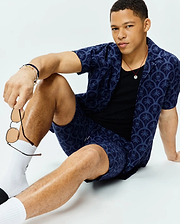 Mens Brad All Over Print Linen Blend Shirt and matching shorts in navy blue, featuring a relaxed fit and an all-over lighter blue print of palm trees and small Psycho Bunny skull logos.