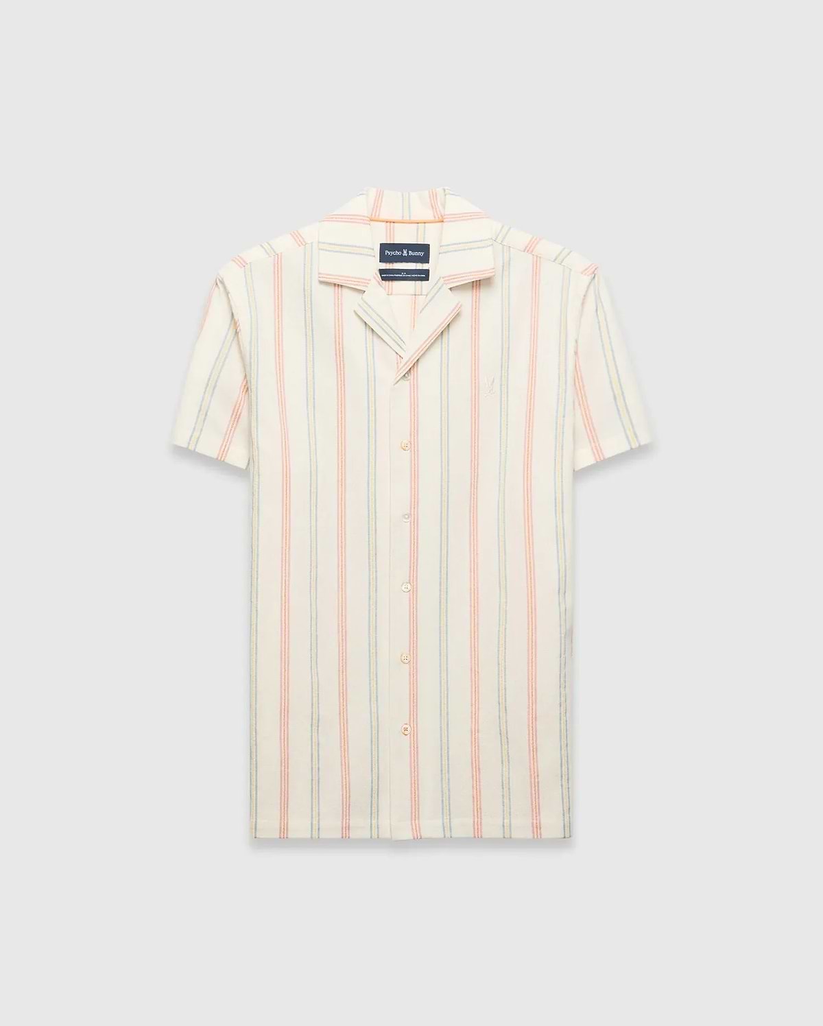 Mens Antoine Shirt: Cream short-sleeve camp collar shirt with vertical thin stripes in light blue, peach, and yellow, featuring a small embroidered Psycho Bunny skull logo on the left chest and a relaxed fit.