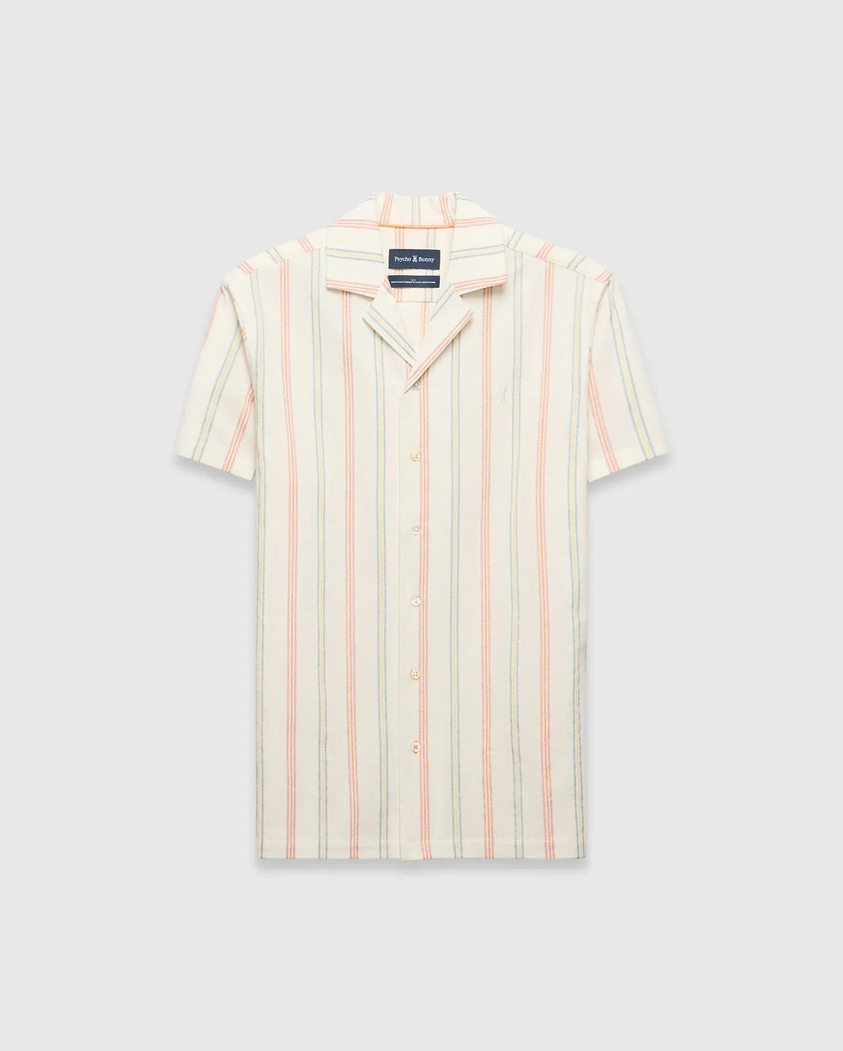 Mens Antoine Shirt: Cream short-sleeve camp collar shirt with vertical thin stripes in light blue, peach, and yellow, featuring a small embroidered Psycho Bunny skull logo on the left chest and a relaxed fit.