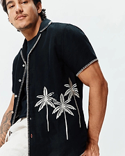 Mens Brad Linen Shirt, black, with prominent white zigzag stitching. Features embroidered silver palm trees and a small black Psycho Bunny skull logo on the chest. Relaxed fit.