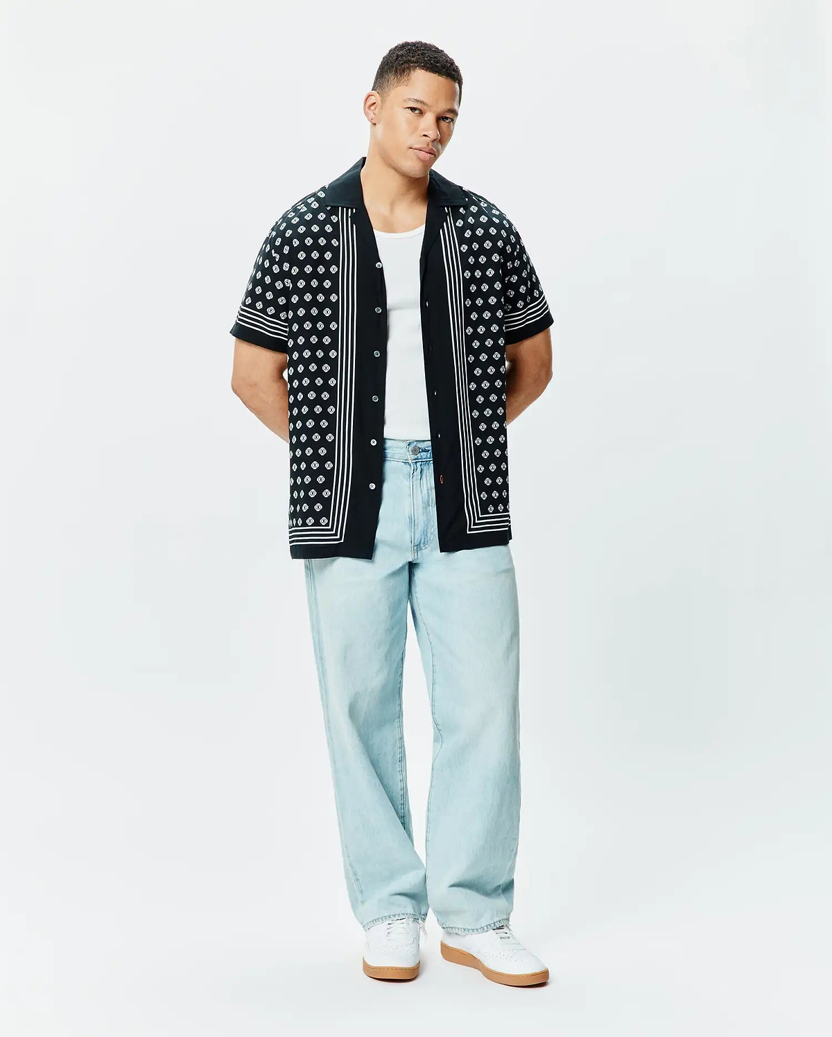 Mens Nick Tencel Shirt, a black short-sleeve camp collar shirt with a white geometric pattern, vertical white stripes on the placket and sleeve cuffs, and a relaxed fit.