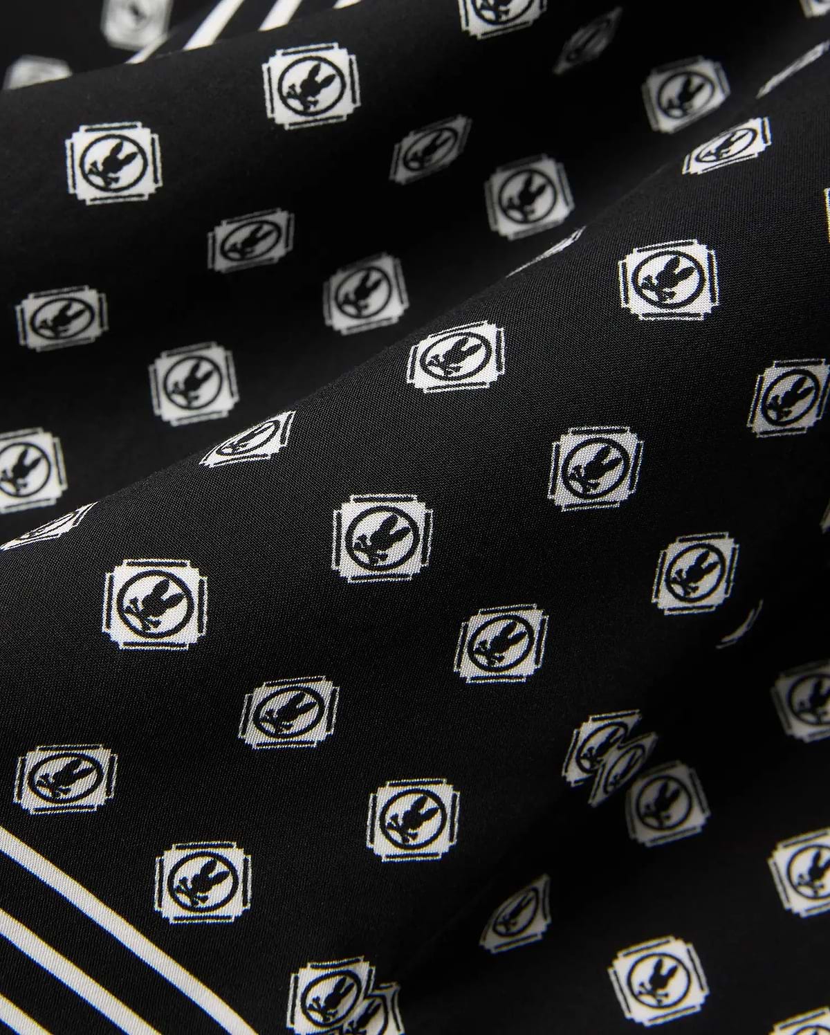 Mens Nick Tencel Shirt in black, featuring a white all-over Psycho Bunny skull logo pattern within square frames and white accent stripes on smooth tencel fabric.