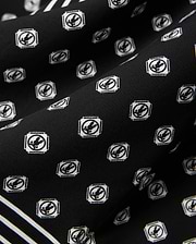 Mens Nick Tencel Shirt in black, featuring a white all-over Psycho Bunny skull logo pattern within square frames and white accent stripes on smooth tencel fabric.