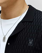 Mens Xandros Knit Shirt in black, featuring a textured checkerboard knit pattern, classic collar, and a tonal embroidered Psycho Bunny skull logo on the left chest.