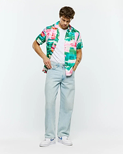 Psycho Bunny Mens Nate Tencel Shirt, a relaxed fit short-sleeve button-up with a vibrant abstract brushstroke pattern in pink, green, teal, and white, embodying refined streetwear.