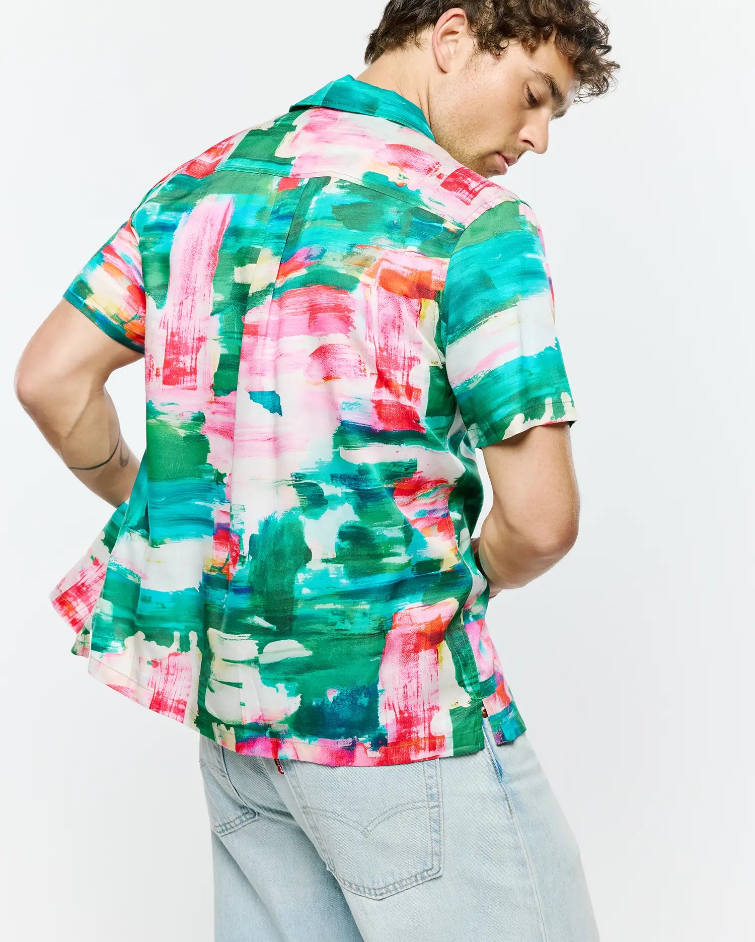 Mens Nate Tencel Shirt, a relaxed fit short-sleeve button-up shirt crafted from smooth Tencel fabric, featuring a vibrant abstract brushstroke print in green, pink, red, blue, and white.