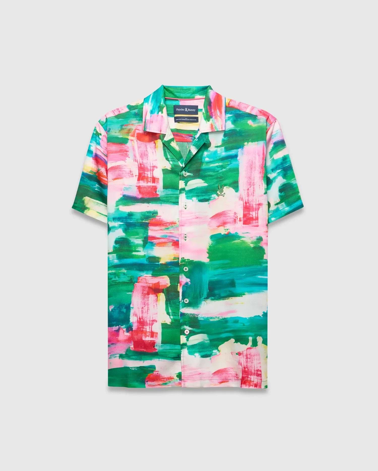 Mens Nate Tencel Shirt, a relaxed fit short-sleeve camp collar shirt in smooth Tencel, featuring a vibrant abstract brushstroke print in green, pink, red, and white, with a small embroidered Psycho Bunny skull logo on the left chest.
