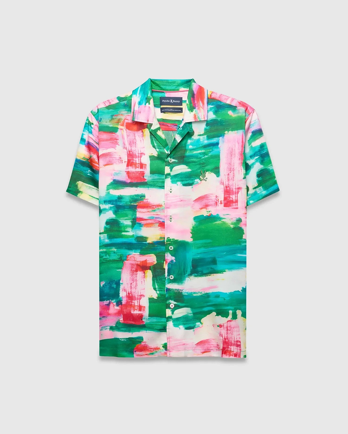 Mens Nate Tencel Shirt, a relaxed fit short-sleeve camp collar shirt in smooth Tencel, featuring a vibrant abstract brushstroke print in green, pink, red, and white, with a small embroidered Psycho Bunny skull logo on the left chest.