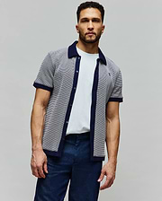 Mens Maxton Waffle Shirt, a classic fit short-sleeve button-up in a white and navy micro-patterned waffle knit, featuring a navy collar, placket, and cuffs, with a small embroidered Psycho Bunny skull logo on the left chest.