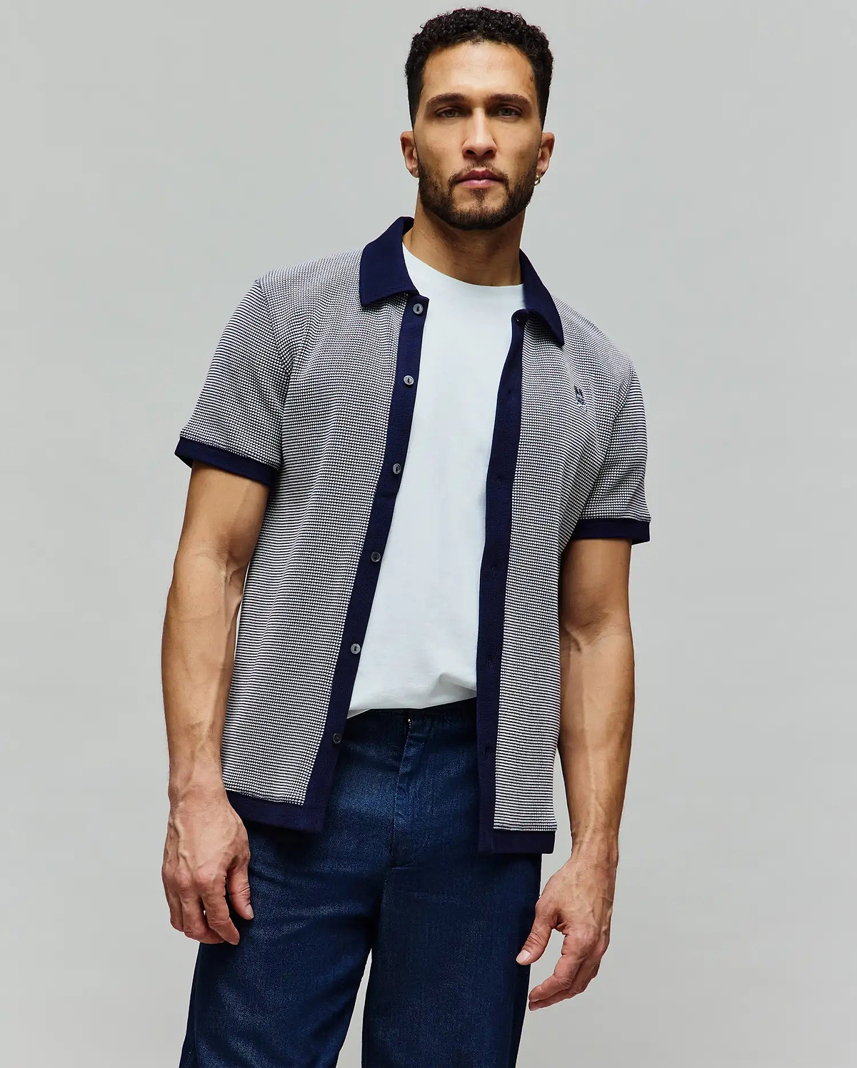 Mens Maxton Waffle Shirt, a classic fit short-sleeve button-up in a white and navy micro-patterned waffle knit, featuring a navy collar, placket, and cuffs, with a small embroidered Psycho Bunny skull logo on the left chest.