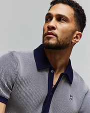 Mens Maxton Waffle Shirt, a classic fit polo in navy and white waffle knit, featuring a solid navy collar, placket, cuffs, and a small embroidered Psycho Bunny skull logo on the left chest.