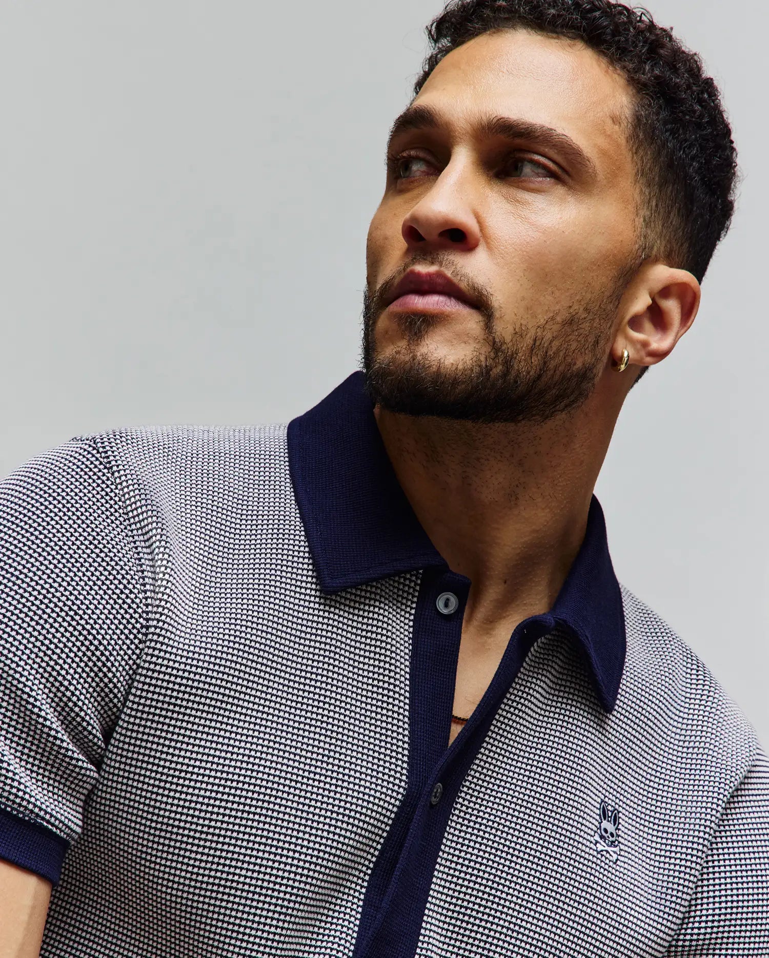 Mens Maxton Waffle Shirt, a classic fit polo in navy and white waffle knit, featuring a solid navy collar, placket, cuffs, and a small embroidered Psycho Bunny skull logo on the left chest.