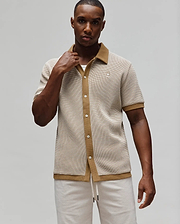 Mens Maxton Waffle Shirt, a classic fit short-sleeve button-up in cream and tan waffle knit, featuring a tan spread collar, full placket, and small embroidered Psycho Bunny skull logo on the left chest.