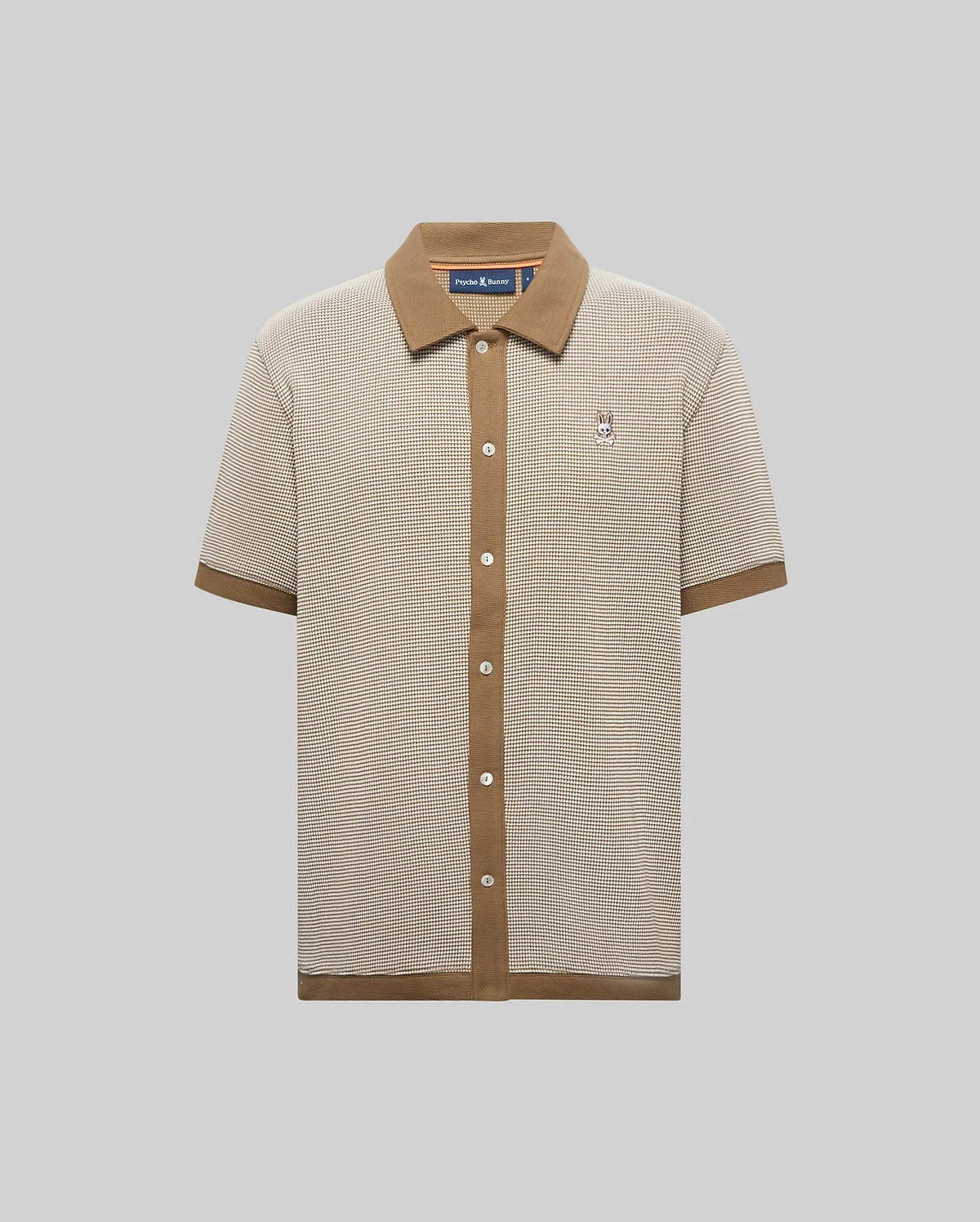 Mens Maxton Waffle Shirt, a classic fit beige and brown micro-check waffle knit shirt with a solid brown ribbed collar, full button placket, cuffs, hem, and an embroidered Psycho Bunny skull logo on the left chest.