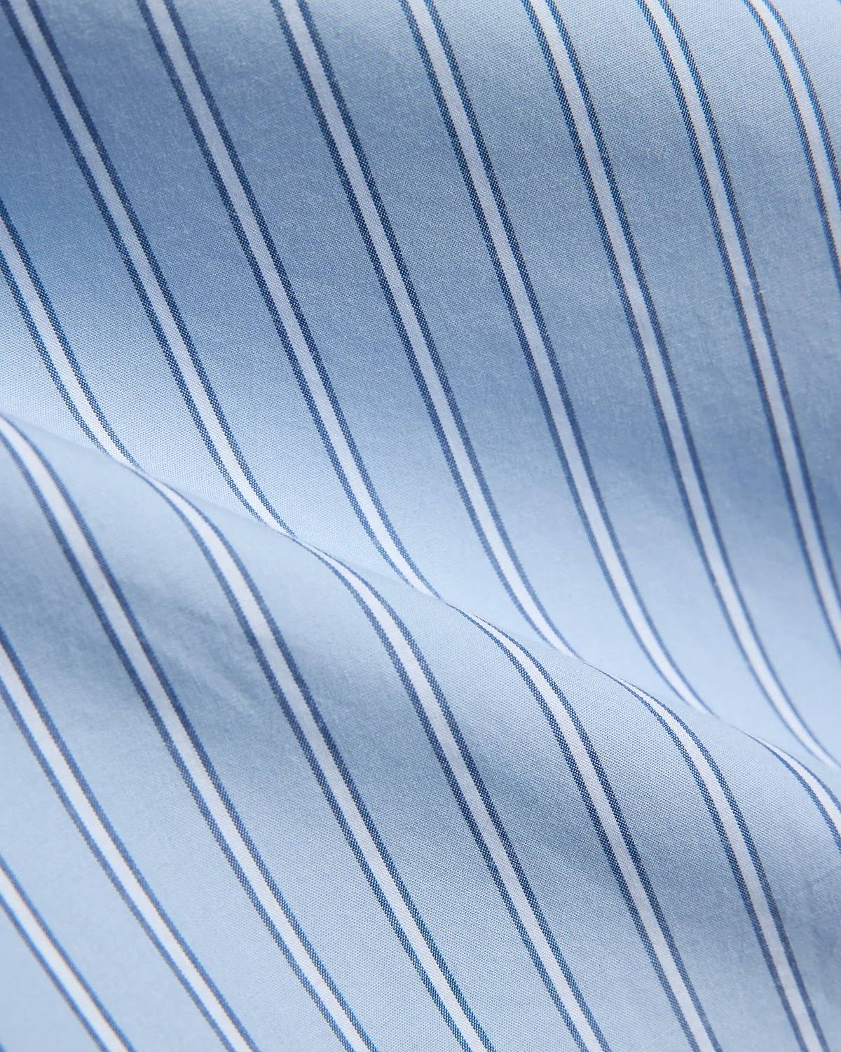 Mens Duncan Stripe Shirt, a light blue fine woven fabric with crisp vertical stripes in white and thin dark blue, showcasing a refined classic pattern.