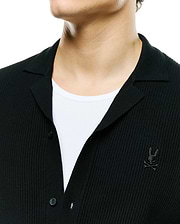 Mens Yann Knit Shirt: Black ribbed knit button-front shirt with a classic spread collar and a small embroidered Psycho Bunny skull logo on the left chest. (2)