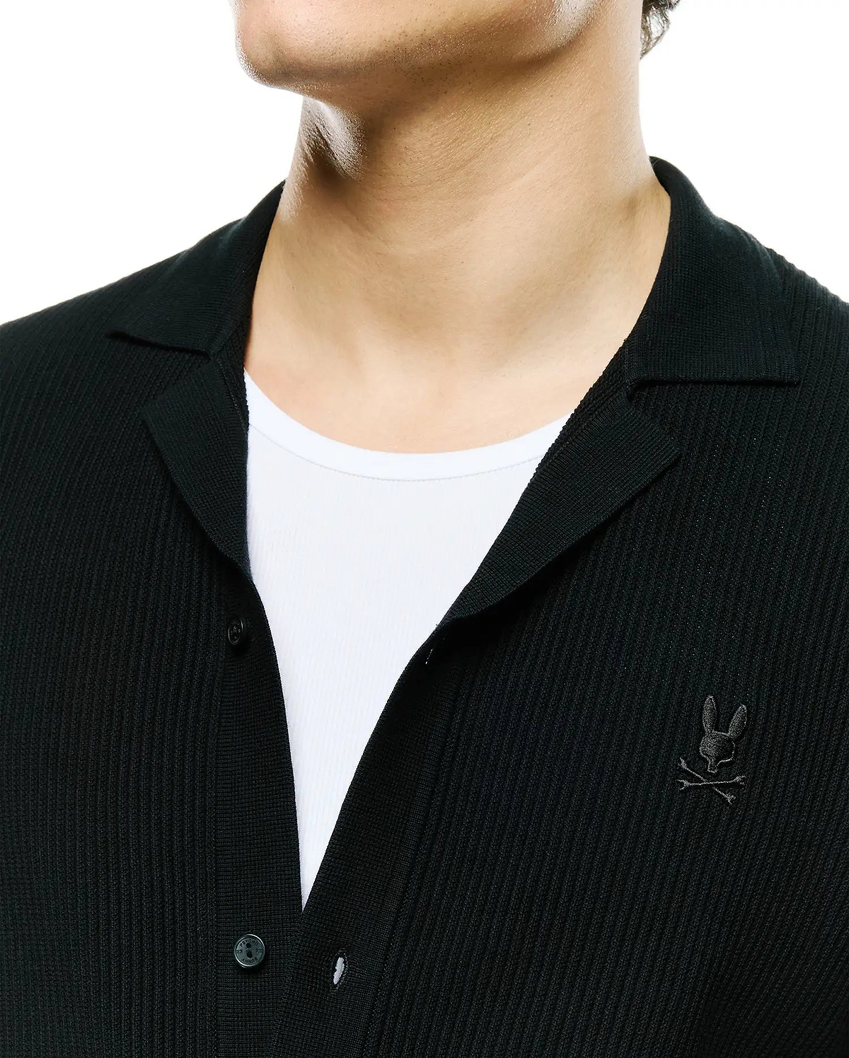 Mens Yann Knit Shirt: Black ribbed knit button-front shirt with a classic spread collar and a small embroidered Psycho Bunny skull logo on the left chest. (2)