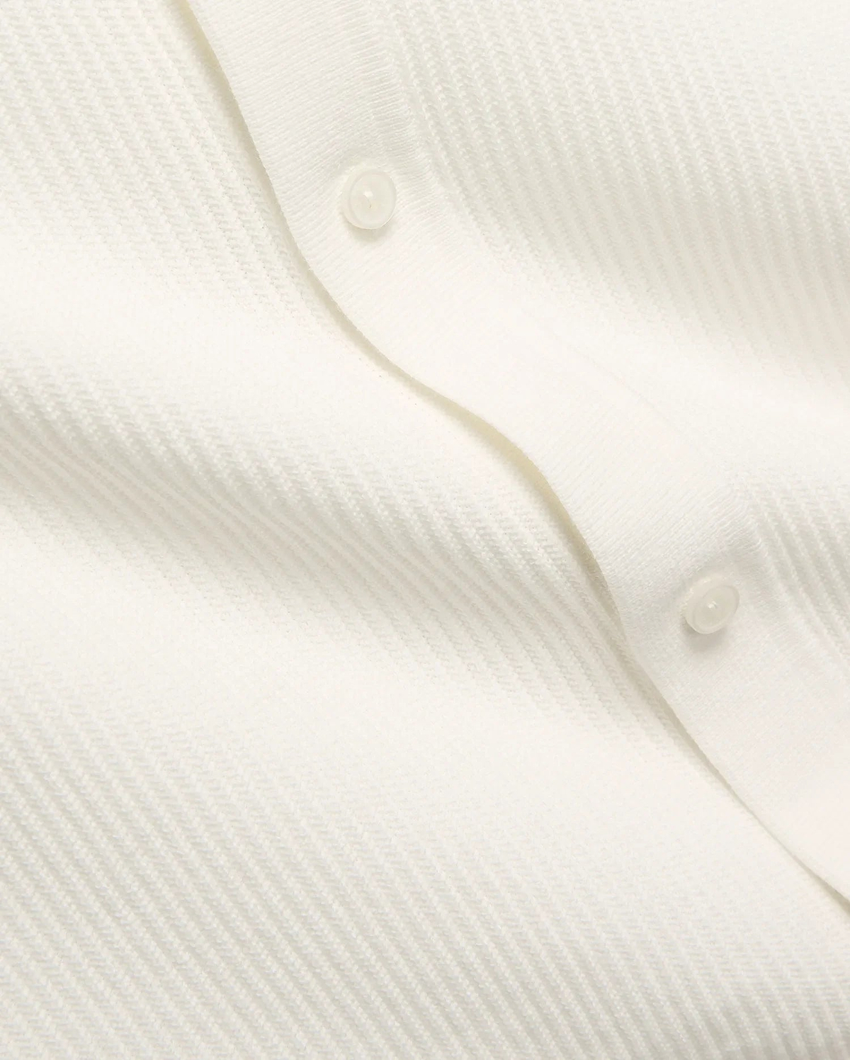 Mens Yann Knit Shirt by Psycho Bunny, a crisp white knit top with a subtle diagonal chevron pattern, featuring a clean button placket with translucent buttons. (7)