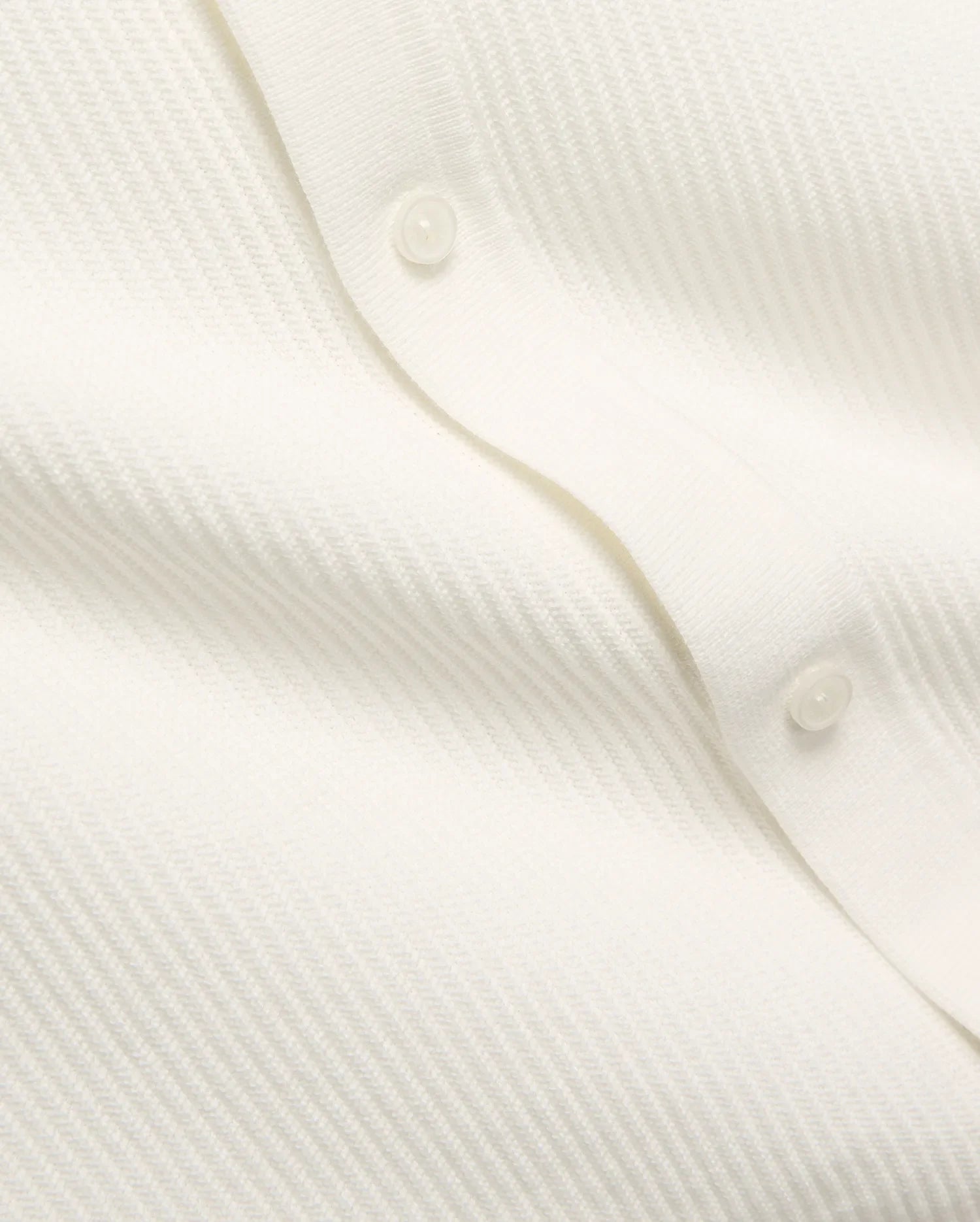 Mens Yann Knit Shirt by Psycho Bunny, a crisp white knit top with a subtle diagonal chevron pattern, featuring a clean button placket with translucent buttons. (7)