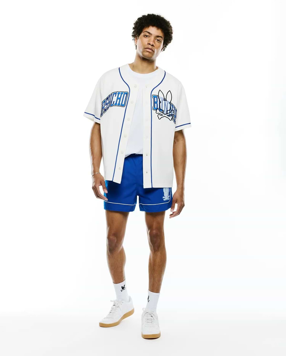 Mens Nathaniel Baseball Shirt, white with royal blue piping, featuring large embroidered PSYCHO text on left chest and BUNNY text with skull logo on right chest, classic fit.