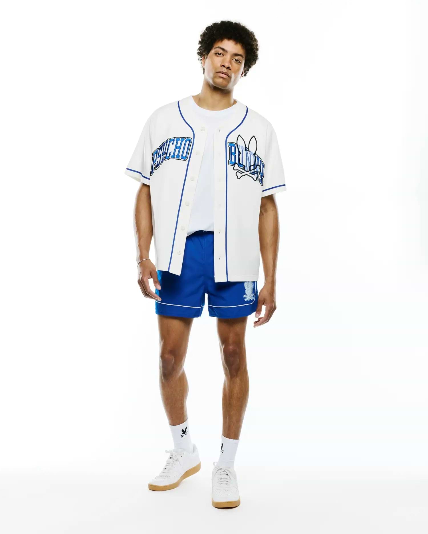 Mens Nathaniel Baseball Shirt, white with royal blue piping, featuring large embroidered PSYCHO text on left chest and BUNNY text with skull logo on right chest, classic fit.