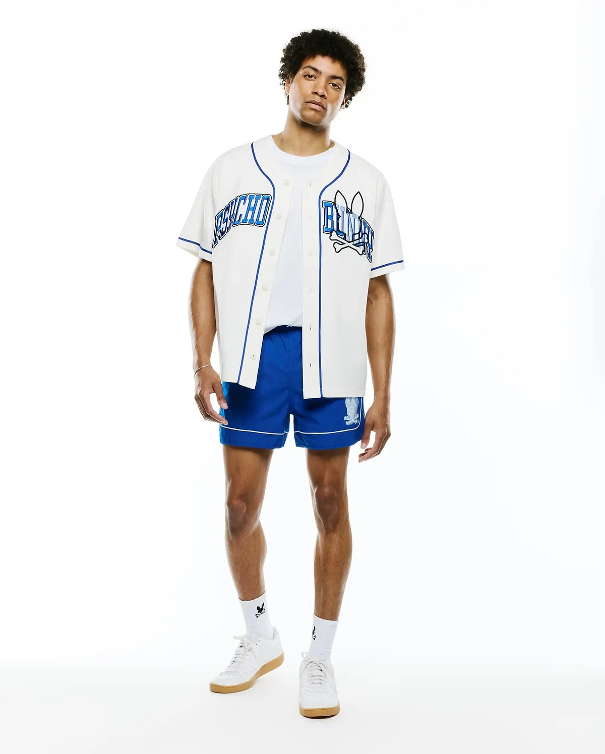 Mens Nathaniel Baseball Shirt, white with royal blue piping, featuring large embroidered PSYCHO text on left chest and BUNNY text with skull logo on right chest, classic fit.