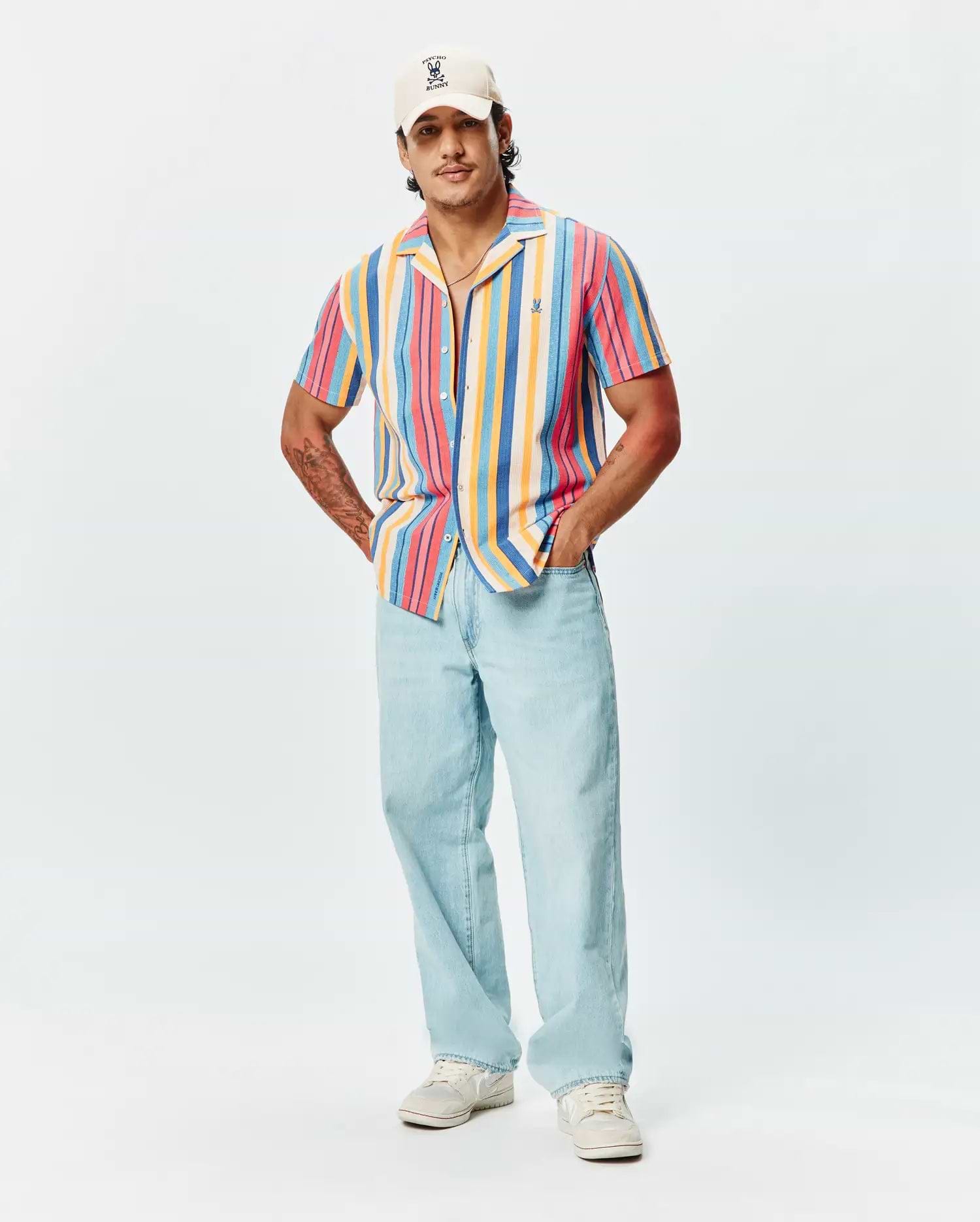 Mens Hubert Knit Shirt, a relaxed fit, short-sleeve, multi-color striped knit shirt featuring a camp collar and small embroidered Psycho Bunny logo on the left chest.
